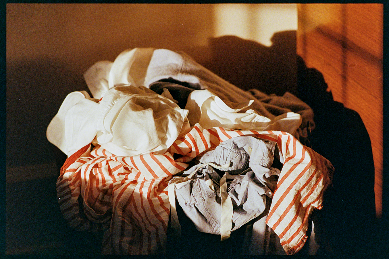 Laundry basket in a bedroom with afternoon light coming in through the window