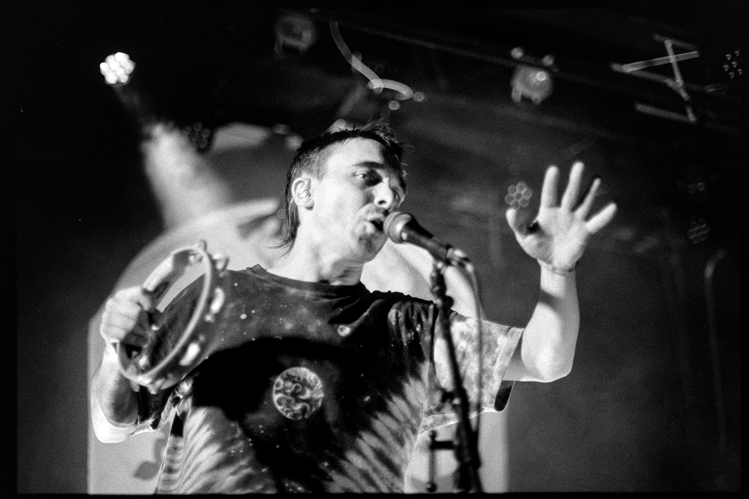Alex playing a tambourine and singing in Rubblebucket concert in St. Paul