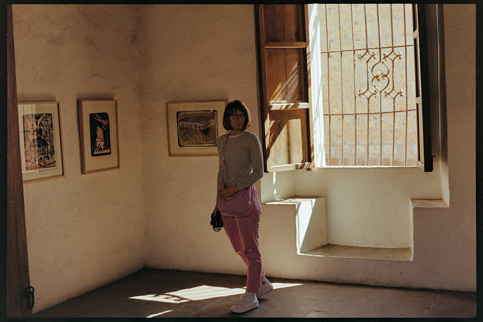 Kallie standing in an art museum with sun streaming in