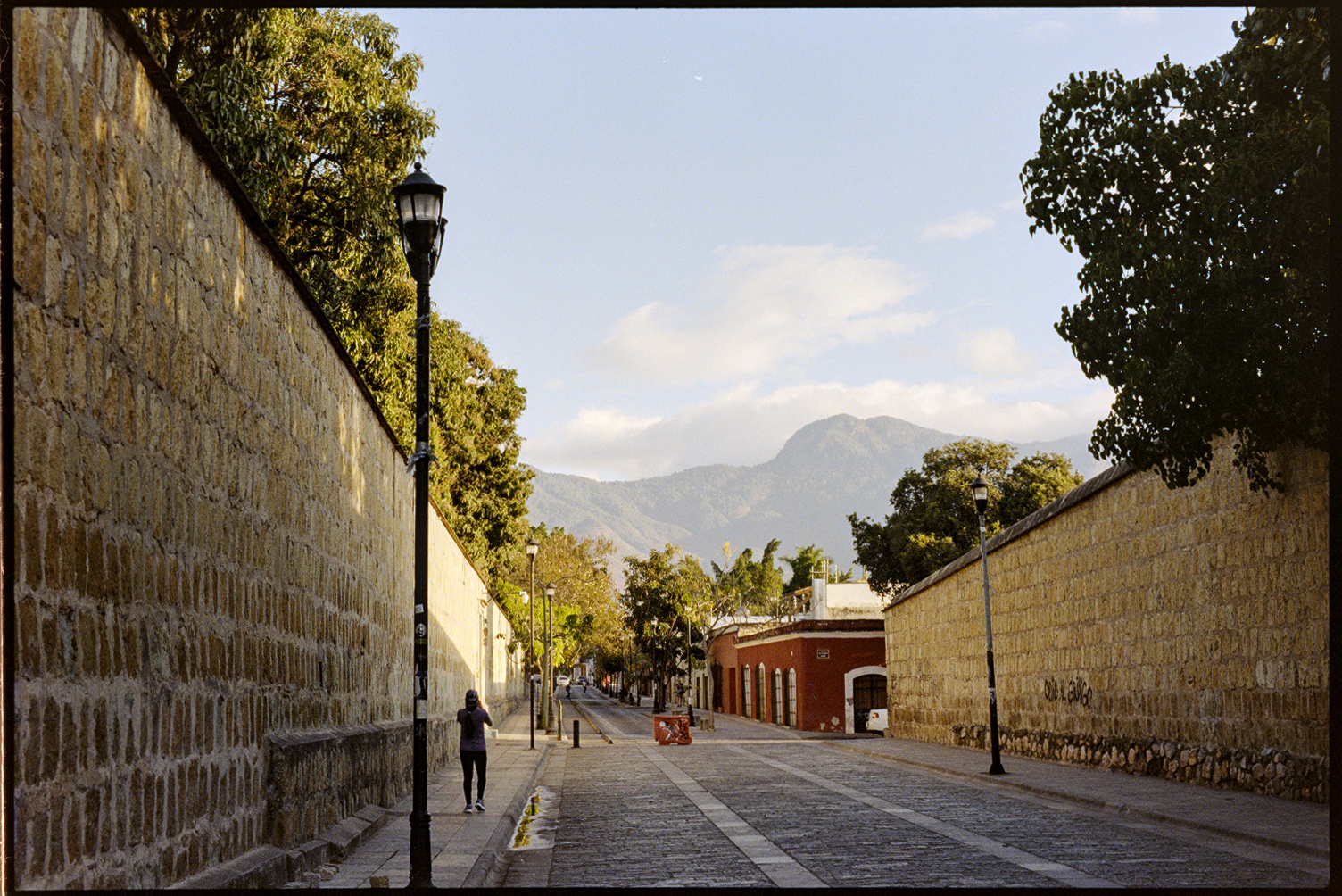 Street flanked with stone walls in the morning sun in Oaxaca City