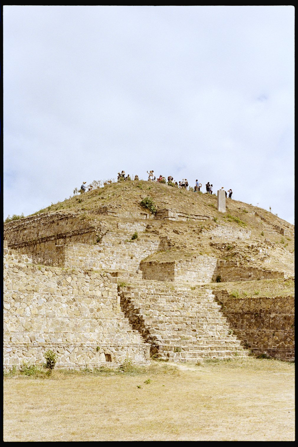 Tourists at the top of a ruin at Monte Alban in Oaxaca City