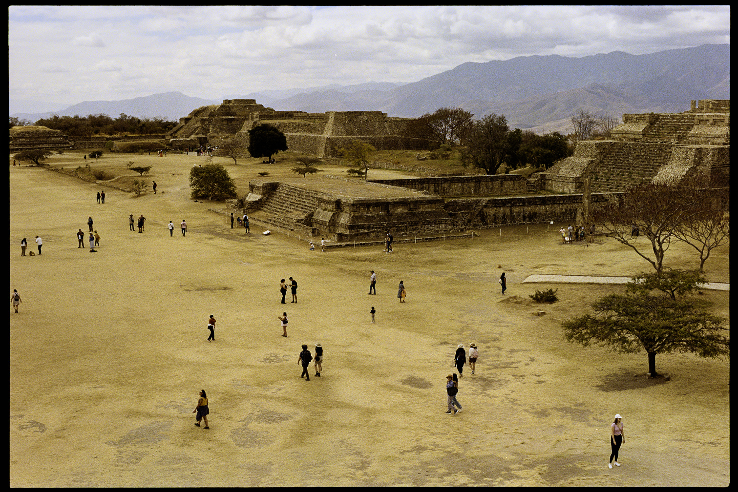 People standing amongst the ruins at Monte Alban in Oaxaca City