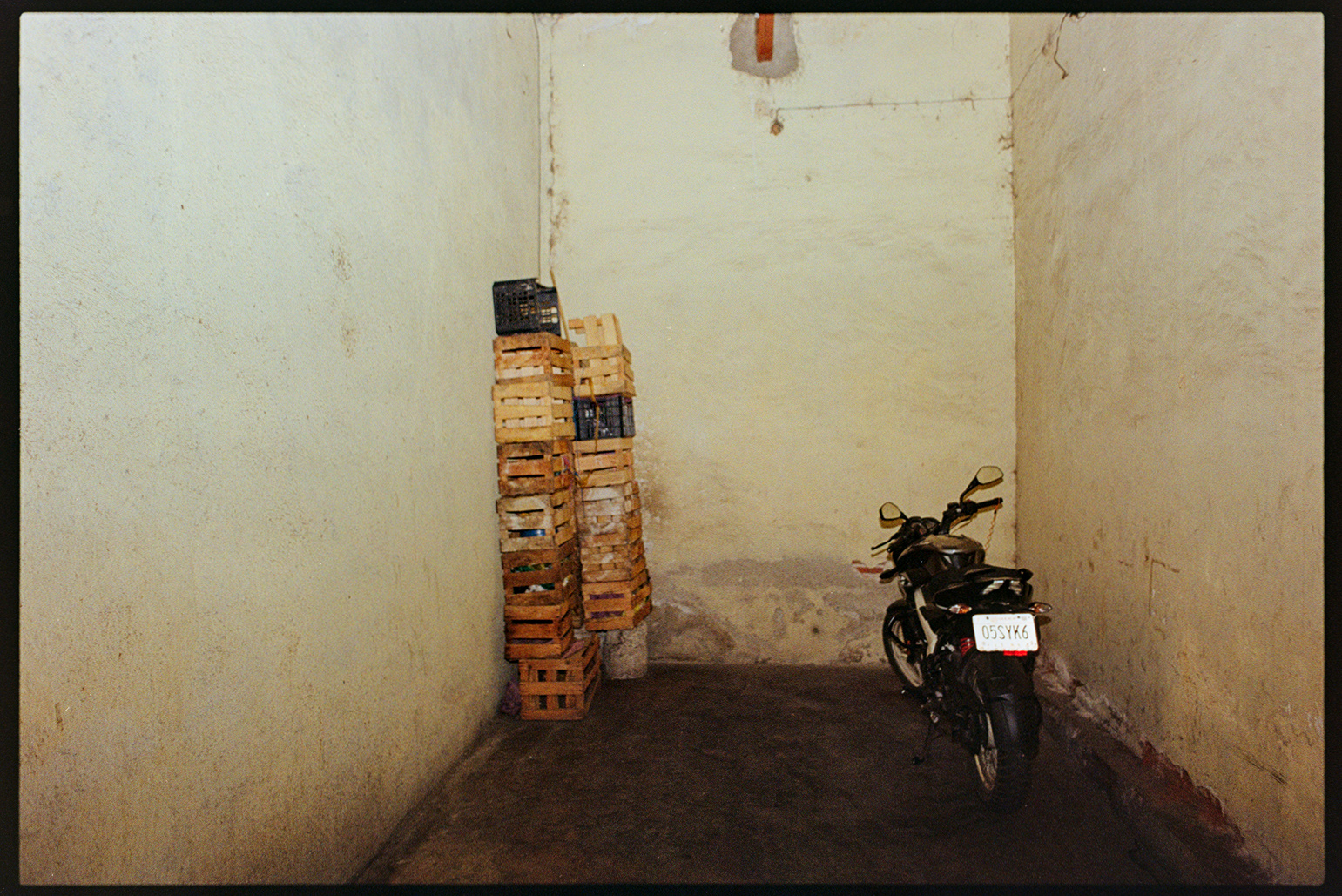 Motorcycle and crate boxes in a storage unit in Oaxaca City