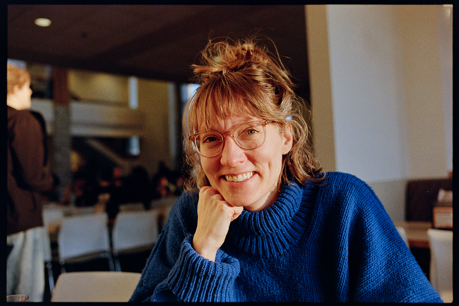 Kallie smiling with her chin on her fist in the evening sun