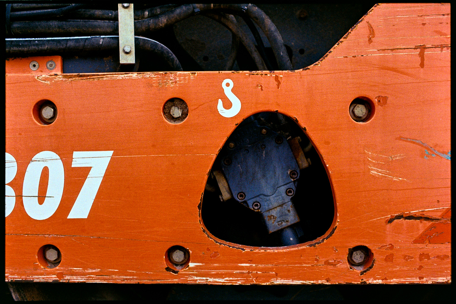 Close up of an orange piece of road construction equipment