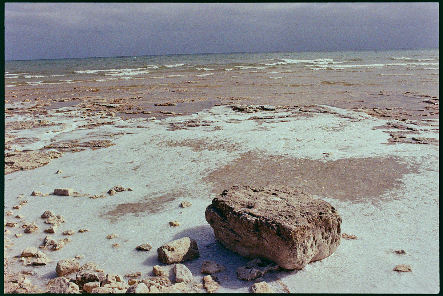 Large stone on a snowy beach at Cana Island in Door County, Wisconsin
