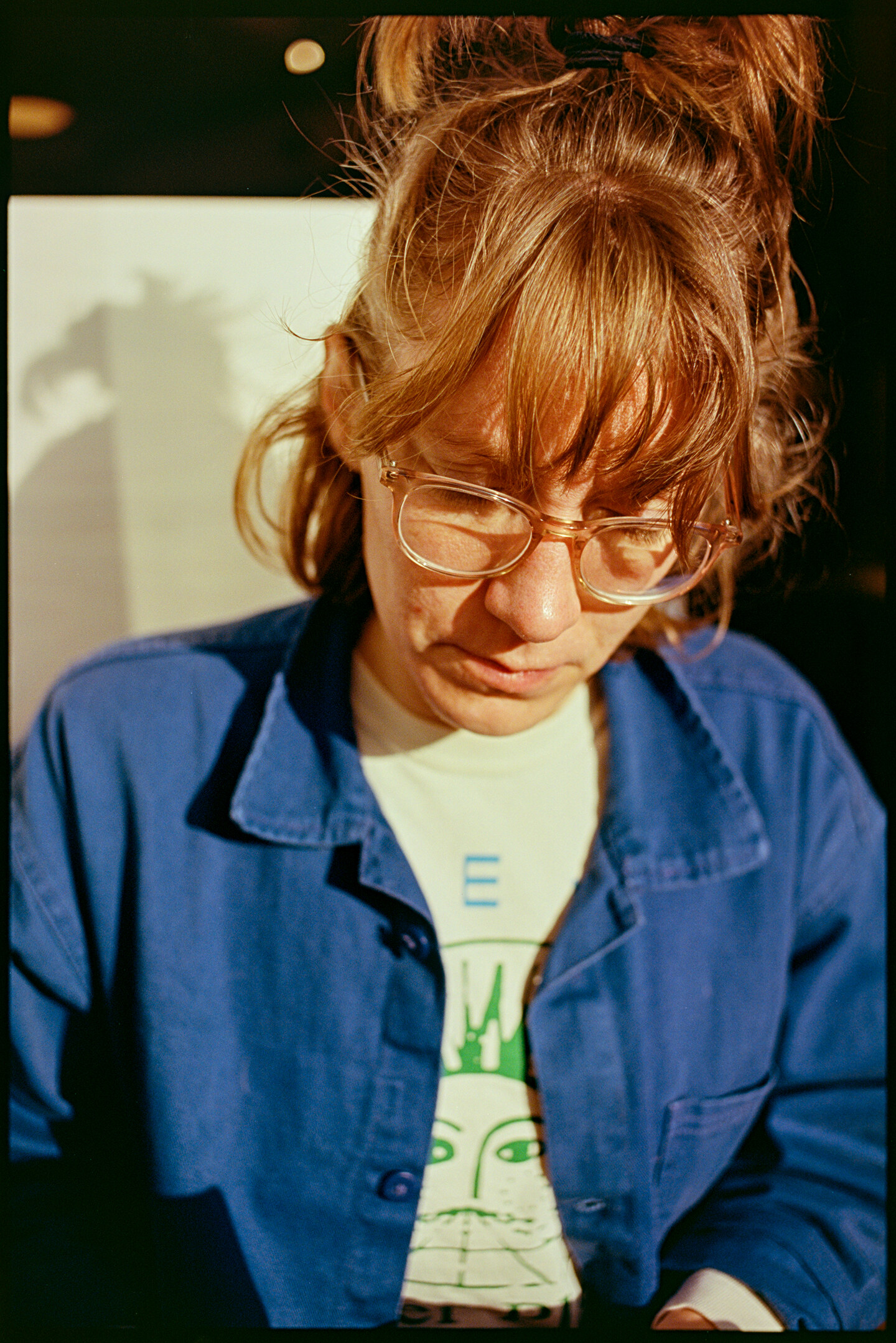 Kallie sitting in a coffee booth in the sun