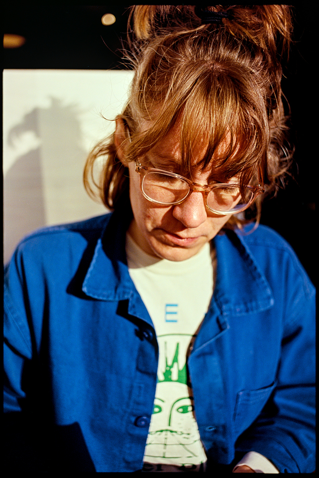 Kallie sitting in a coffee booth in the sun