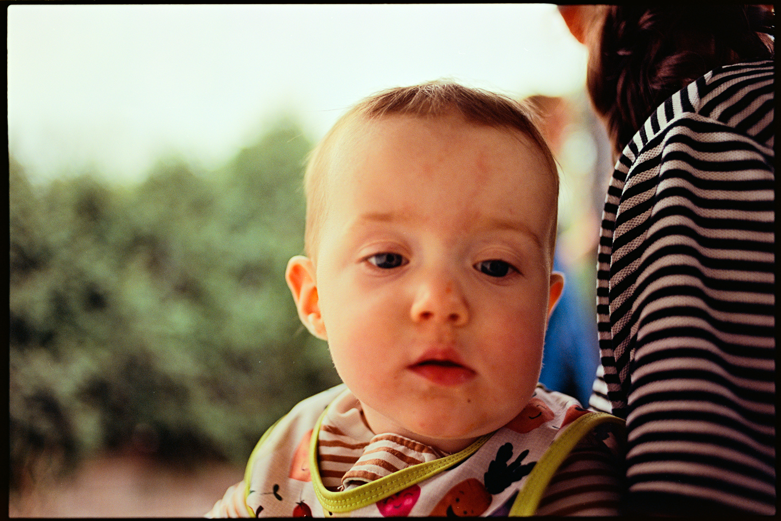 Ada holding Eileen at the cookout