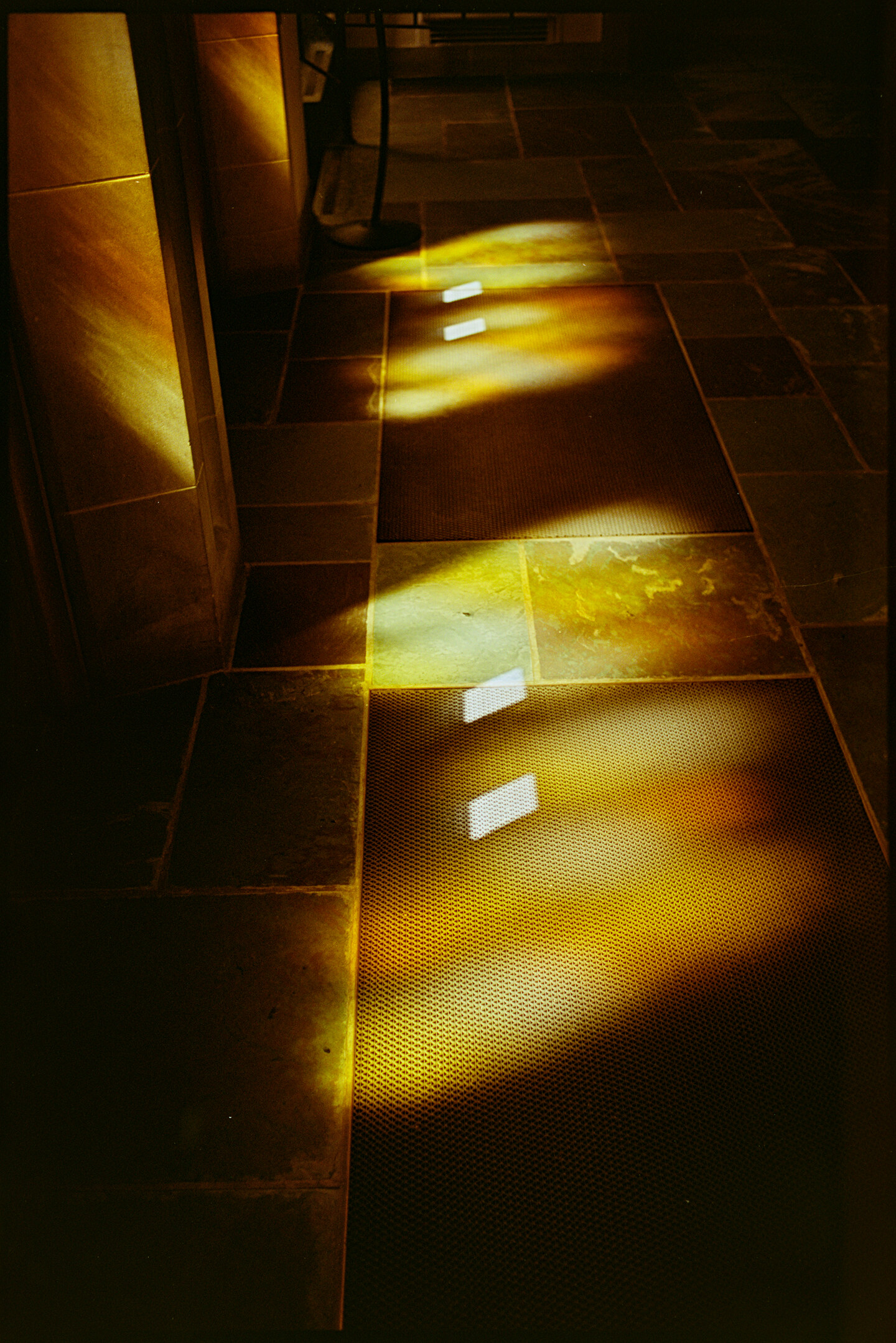 Sun coming through stained glass doors falling on the floor in the chapel