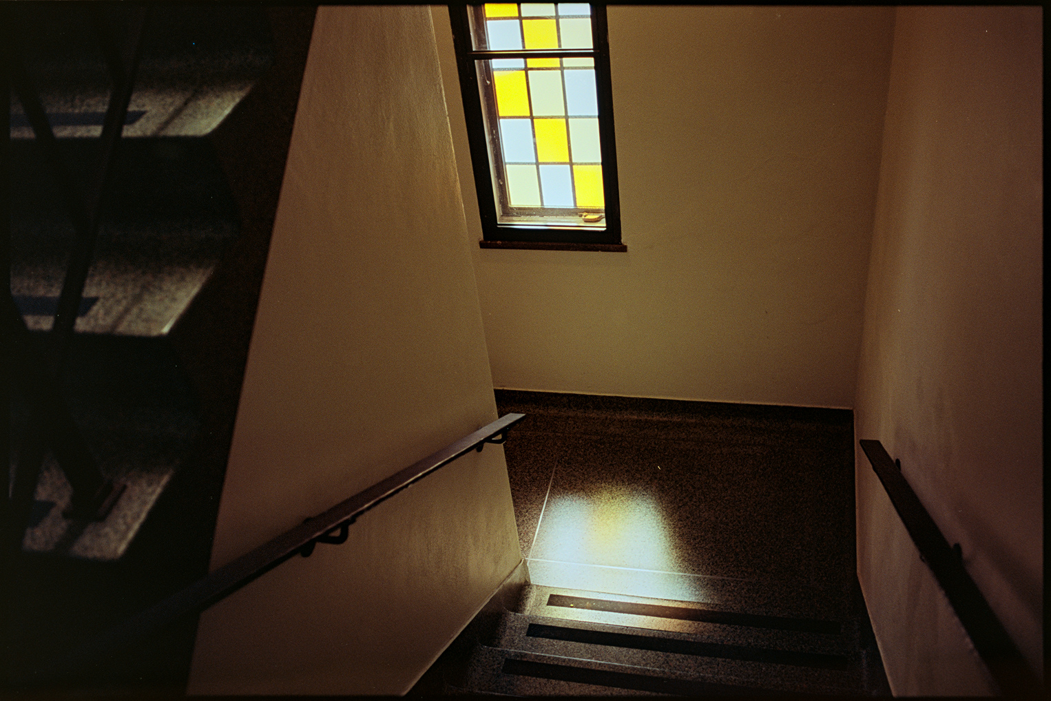 Light coming into a stained glass window in the stairwell of the chapel