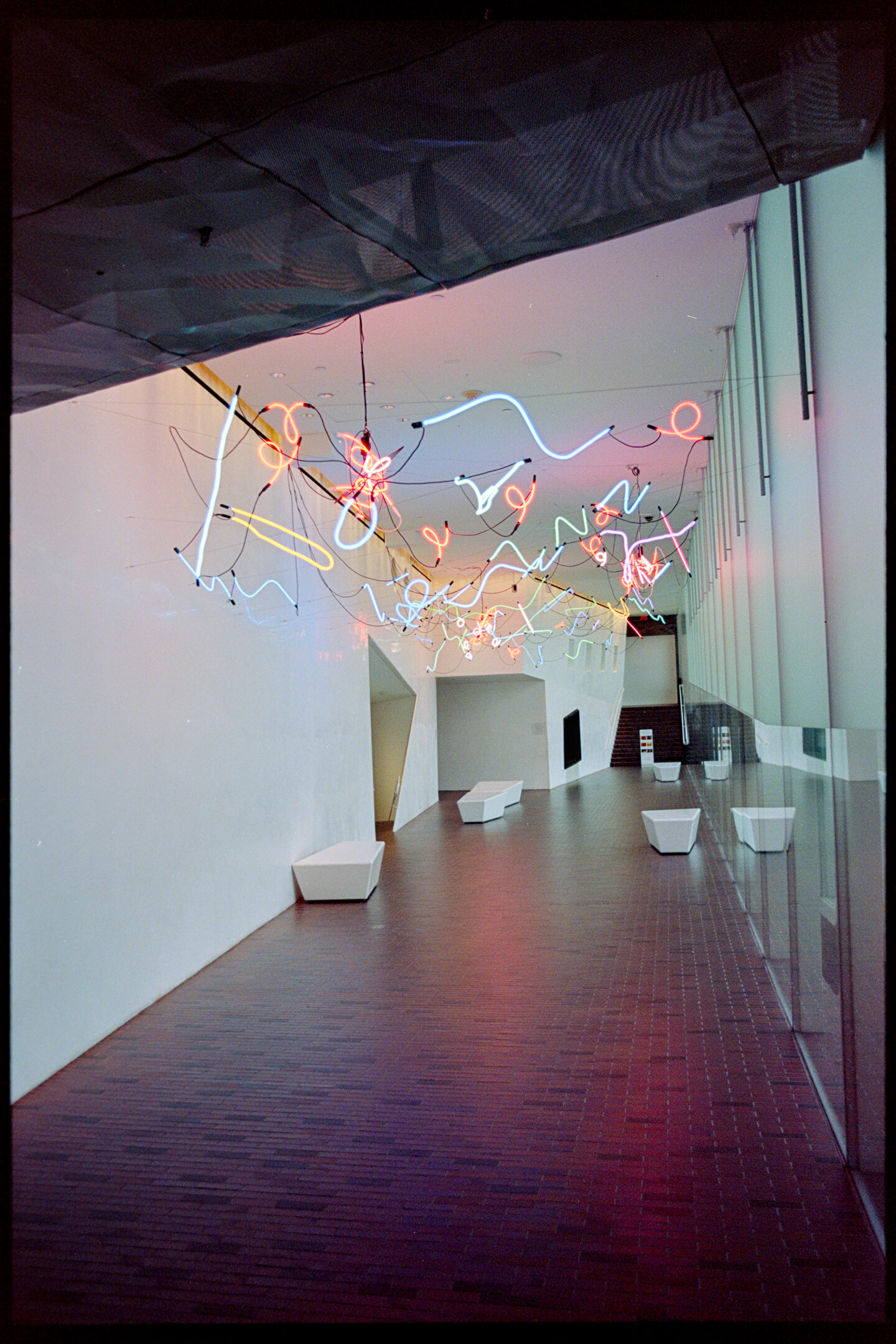 Neon lights hanging from the ceiling in a corridor at the Walker Art Center