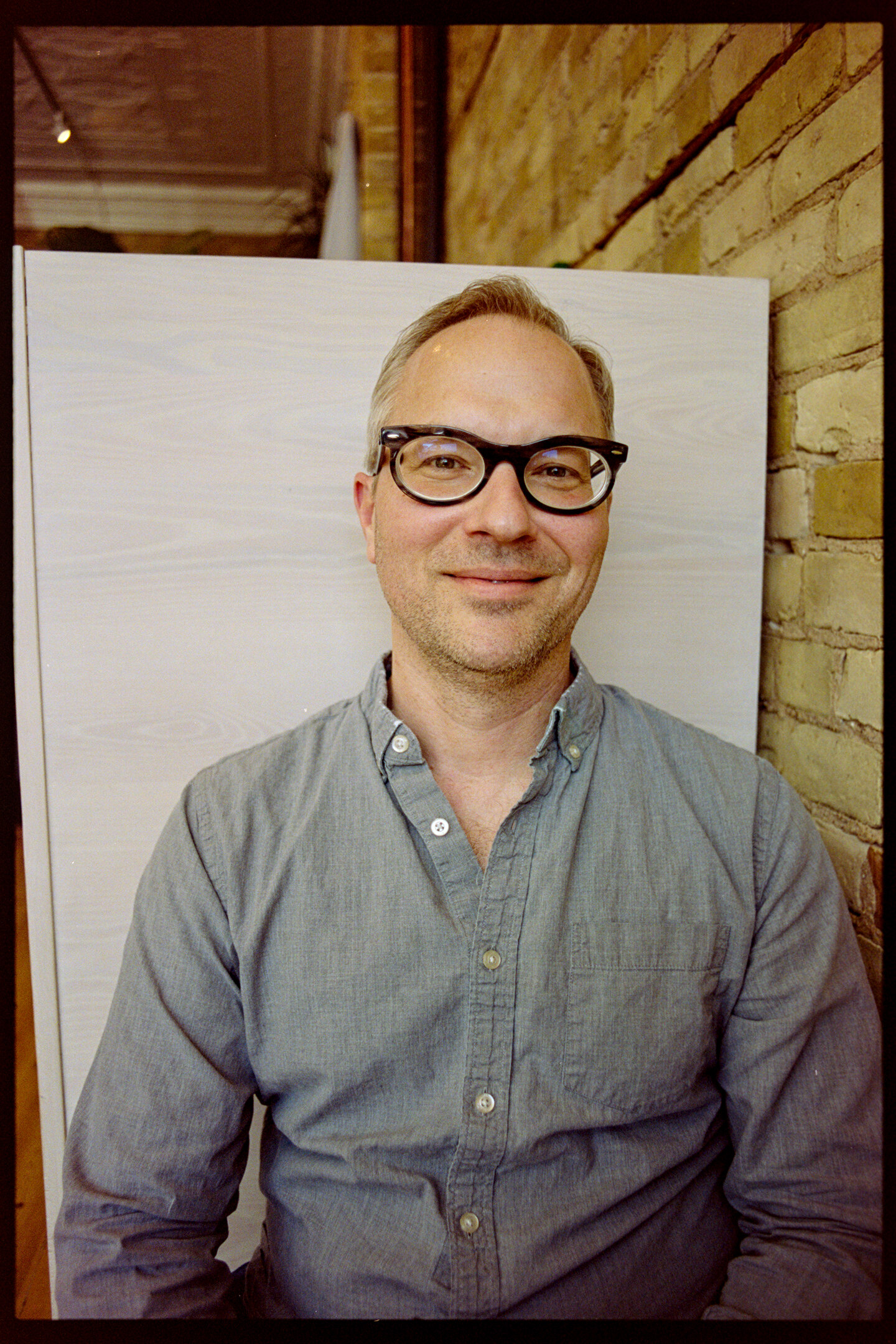 My friend Karl sitting in a booth at Little Joy coffee shop