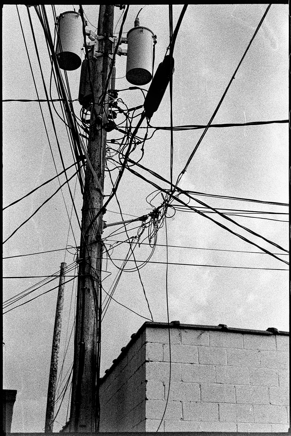 Electrical pole behind a business building after a storm