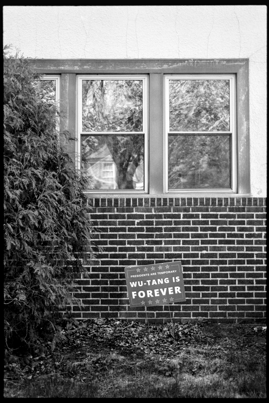Front yard of a house with a lawn sign that says Presidents are temporary, Wu-Tang is forever