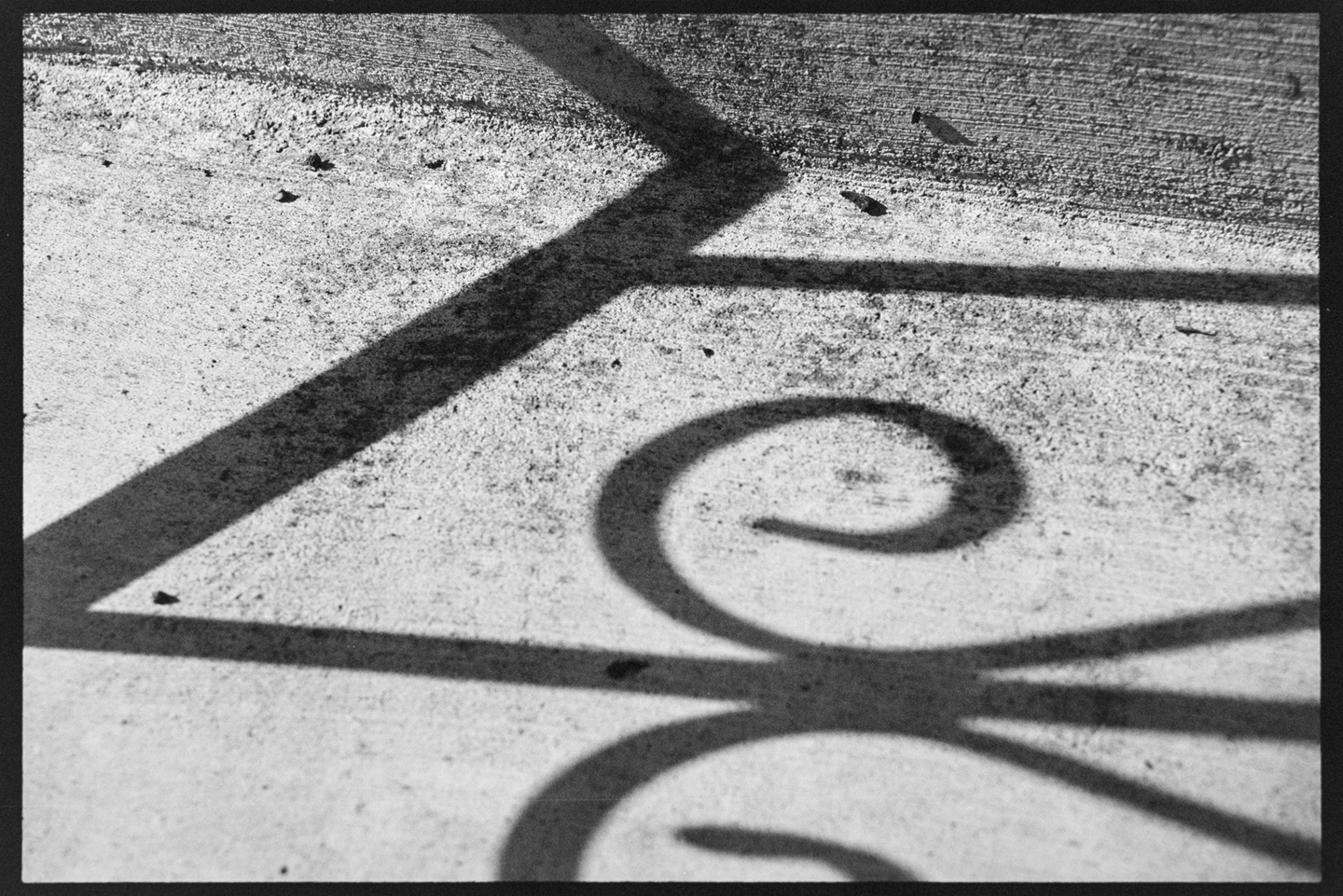 Close up of the railing shadows on the concrete front steps of our house