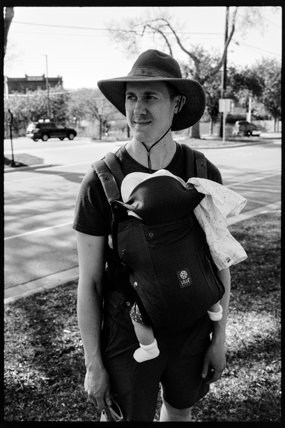 Rob stands with his daughter Sloane in a carrier on his chest