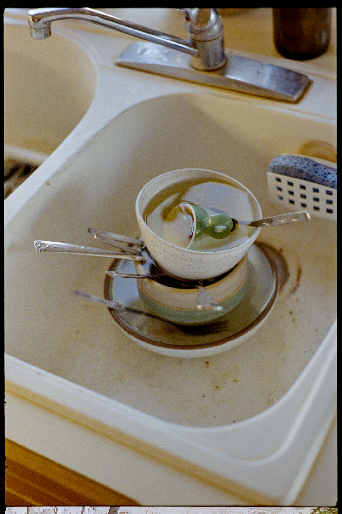 Dirty bowls stacked in the sink