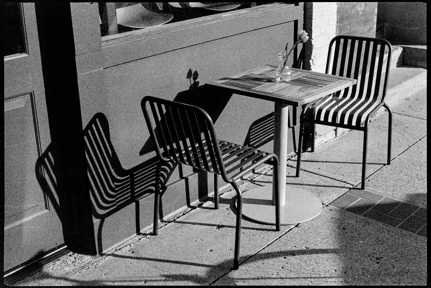 Chairs and table in from of Little Joy Coffee