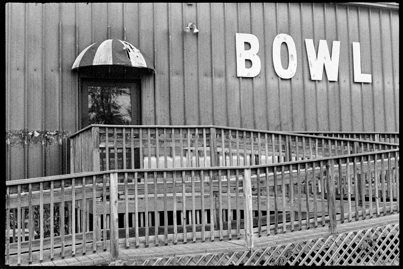 Side of a bowling alley with a sign that says BOWL