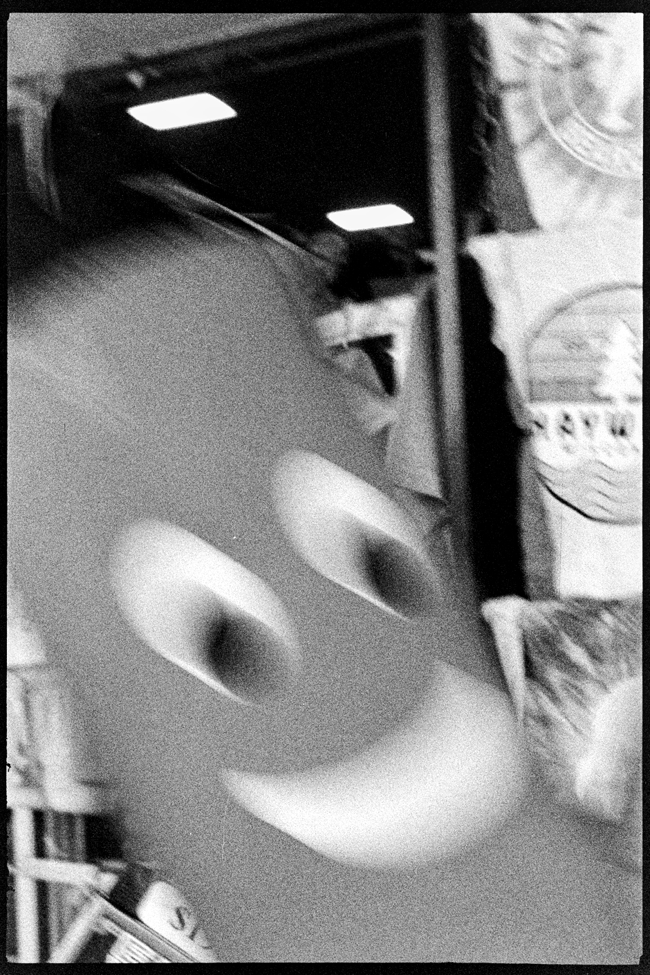 An inflatable noodle man jumping around in front of a t-shirt shop