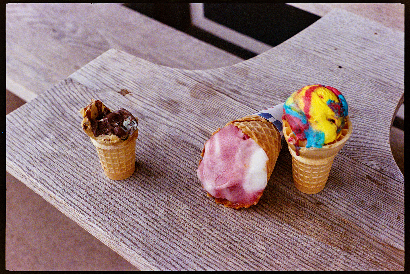 Three abandoned ice cream cones on a bench in Bayfield, Wisconsin