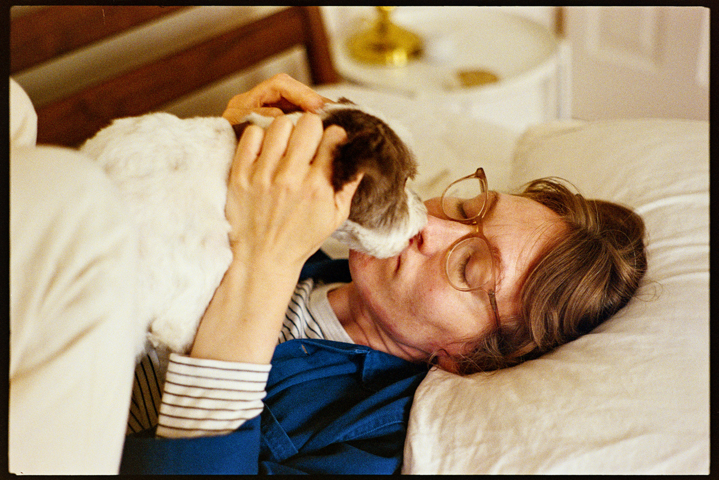 Kallie and her dog Annie cuddling on a bed