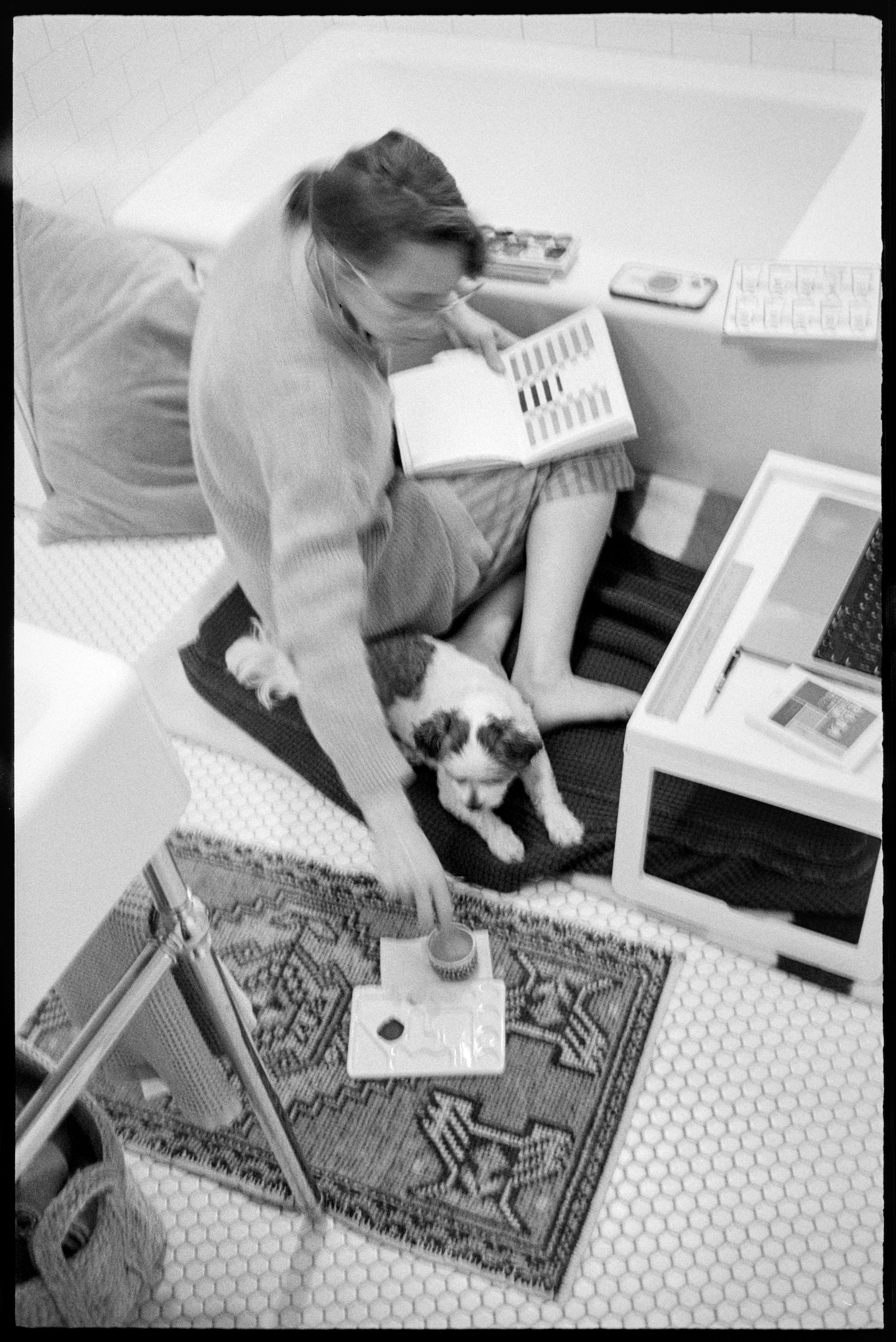 Kallie painting in the bathroom with Annie at her side
