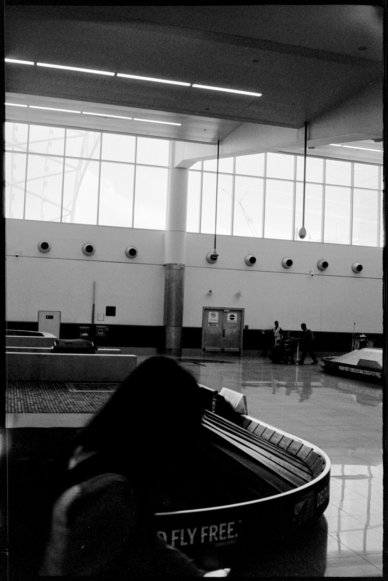 Atlanta airport baggage claim with woman crossing the foreground