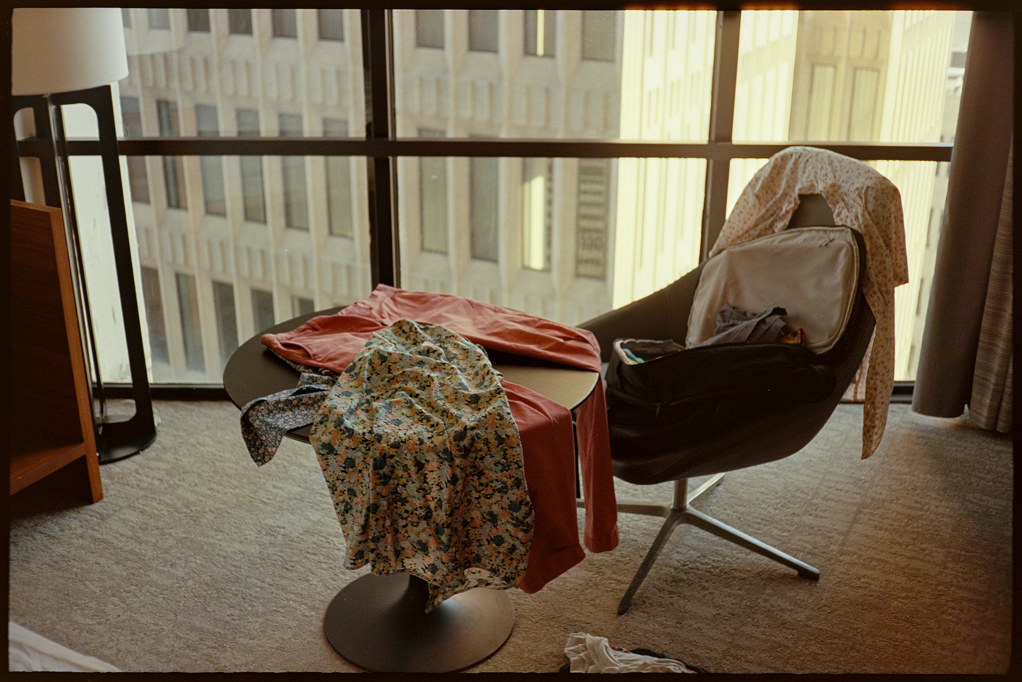 My work clothes draped over a chair and table in my hotel room in Atlanta