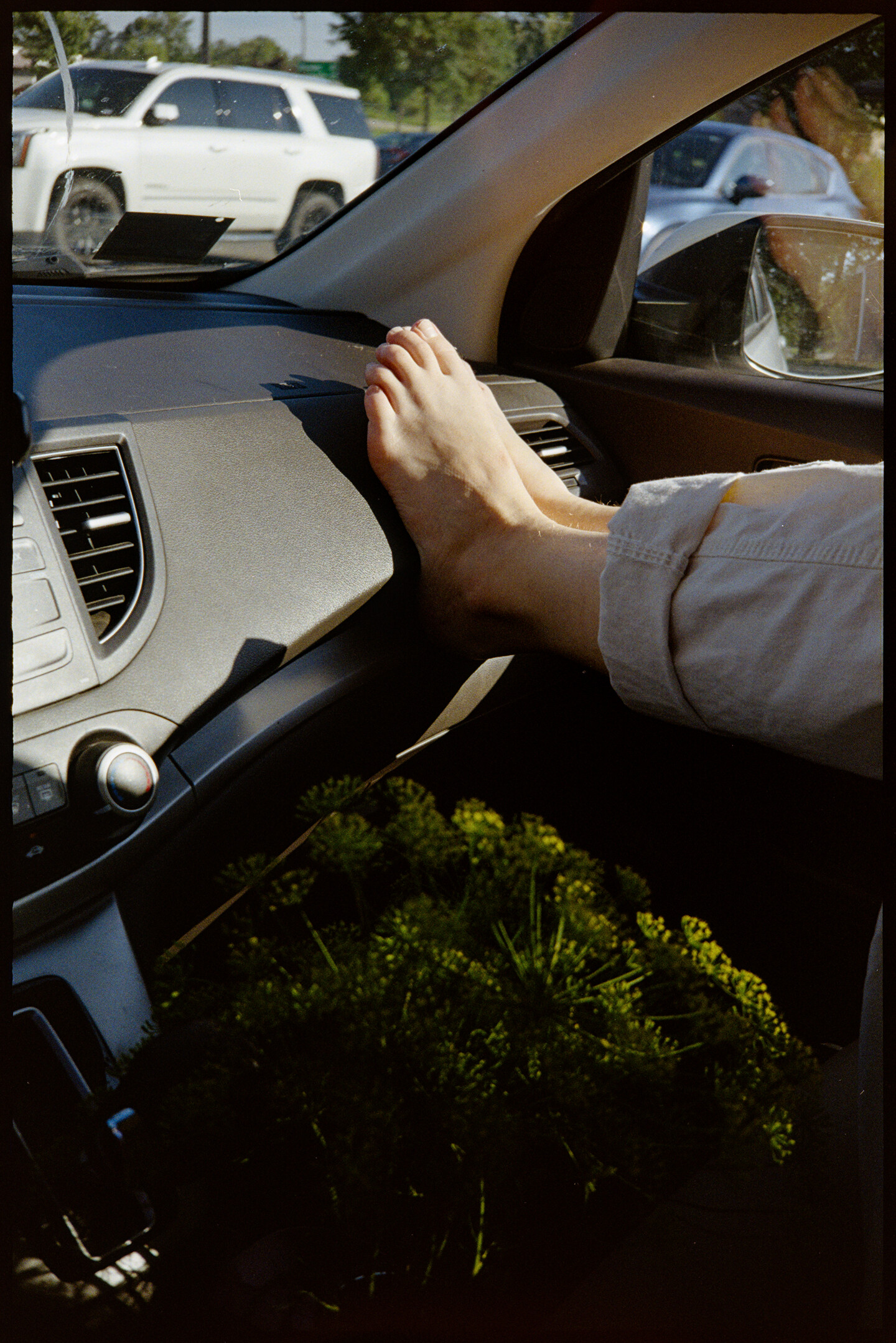 The feet of Kallie on the dashboard of our car as we wait in line in the Tacoasis drive through