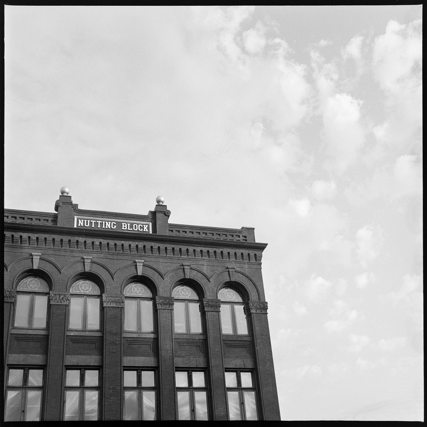 Nutting Block building with cloudy sky behind it