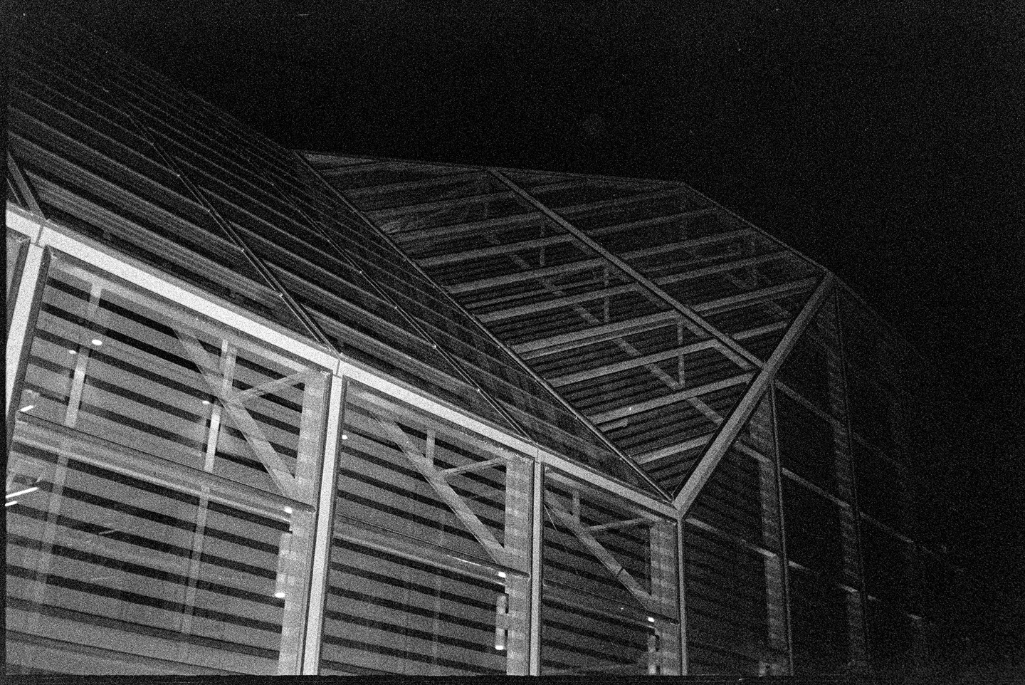 The skeleton of a glass building shot at night in Columbus, Indiana