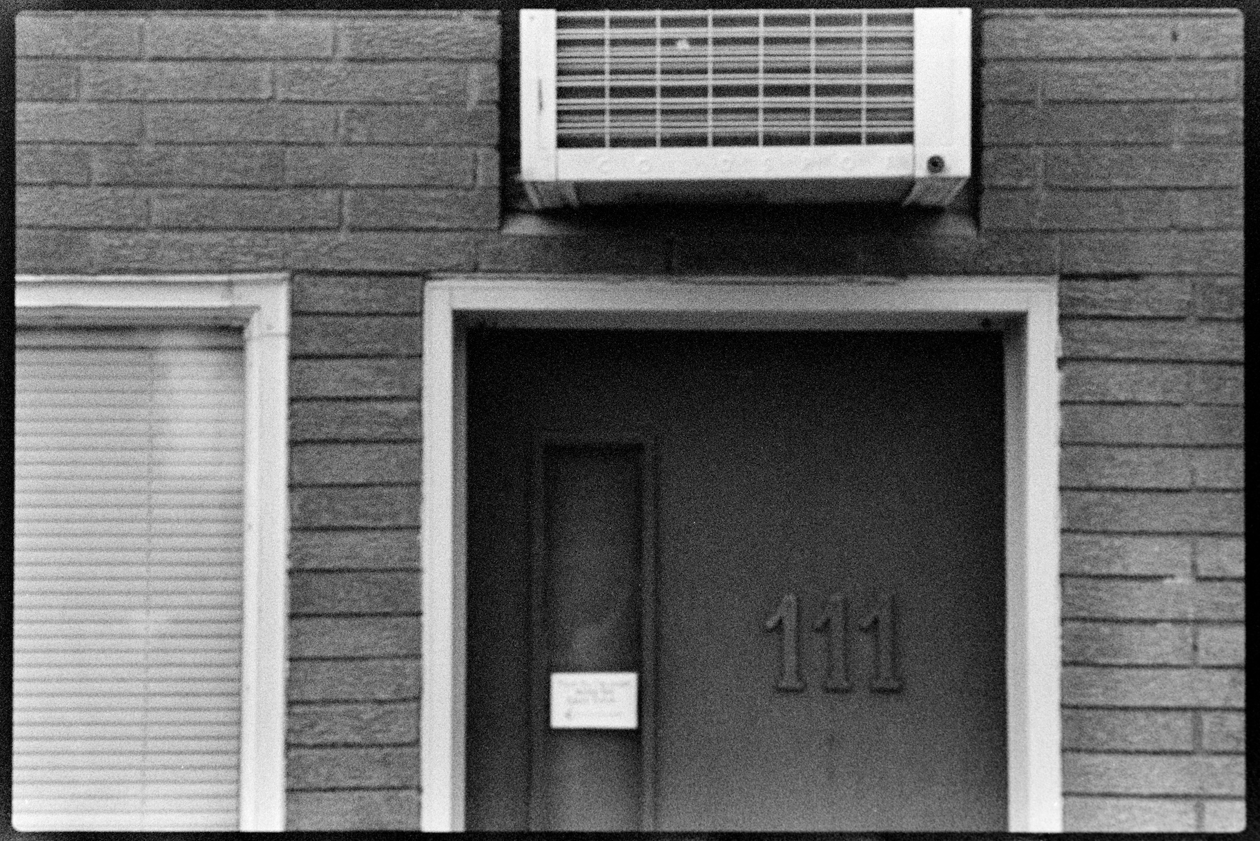 Door to apartment with AC unit above it