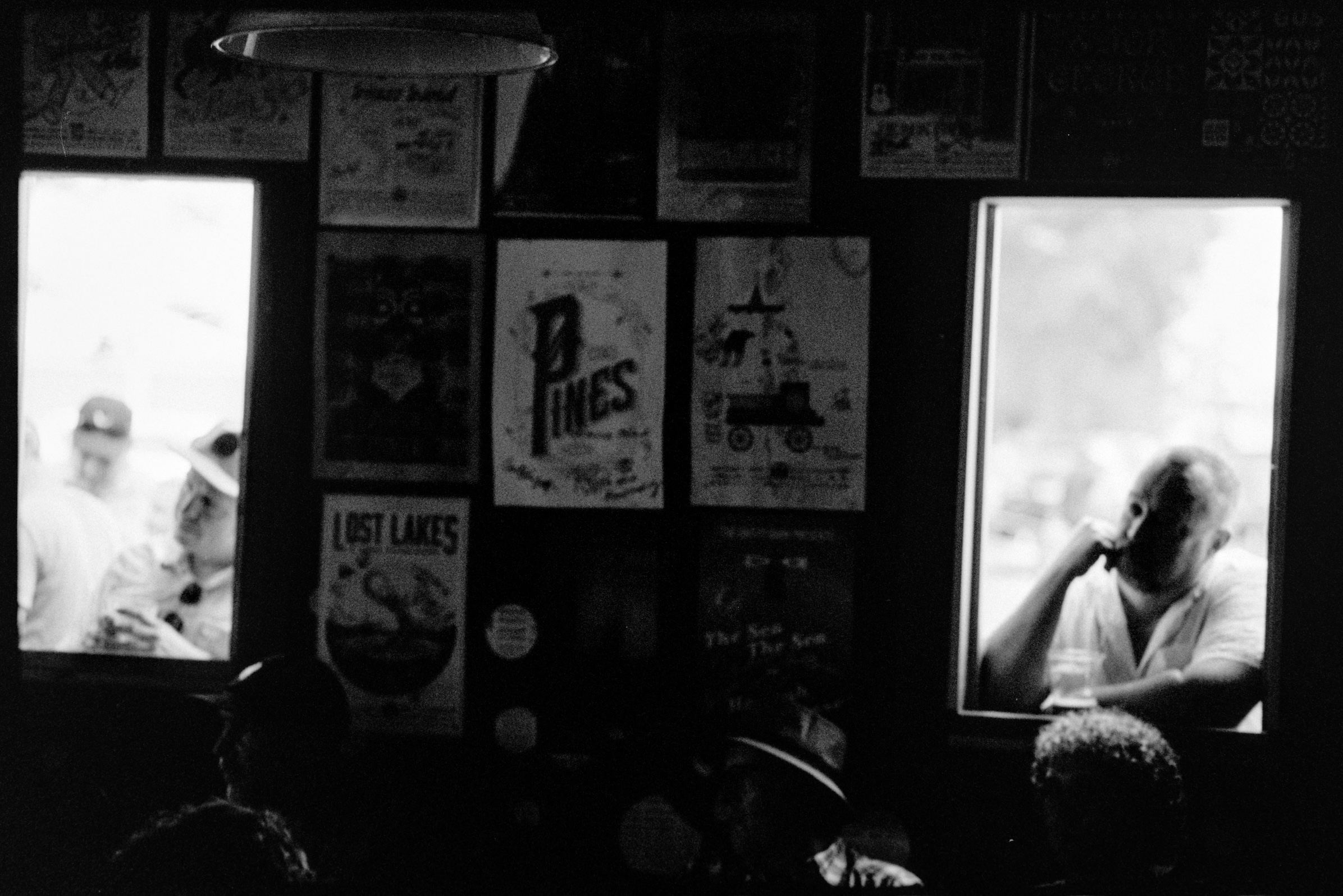 Audience members watching concert through windows at the Shitty Bard