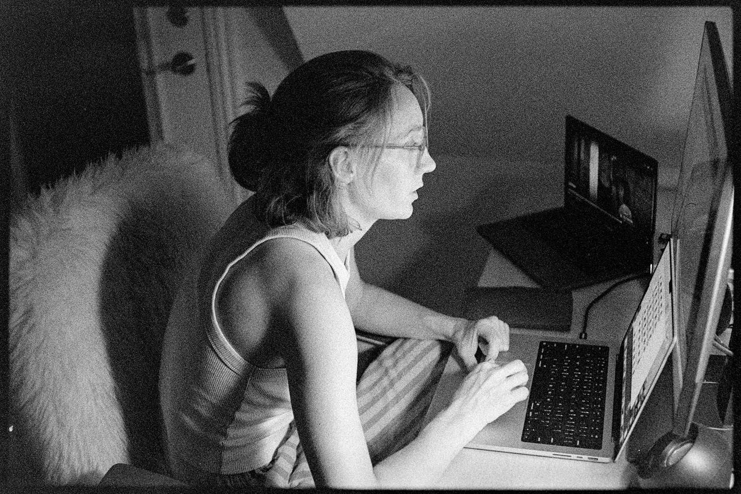 Kallie sitting in the light of her desk at nighttime