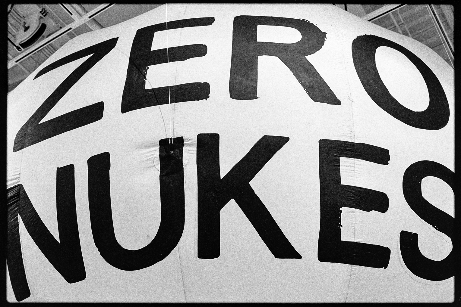 A large inflated white object with the words 'zero nukes' painted on it in an art exhibition