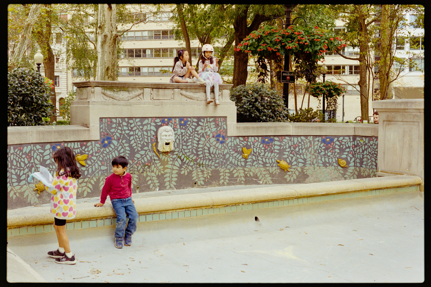 Children hanging out at the empty fountain in Rittenhouse Square