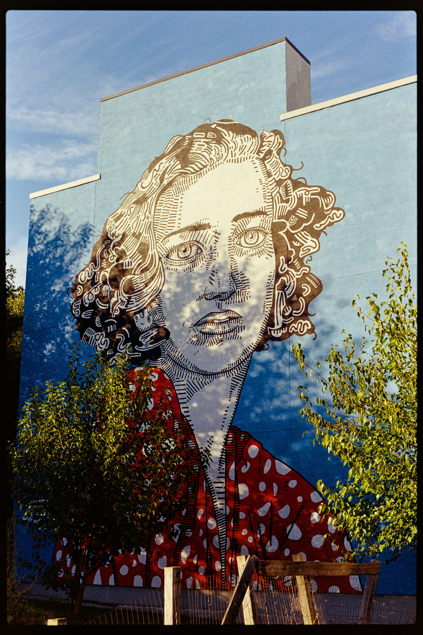 Mural of a woman on the side of a building in Fishtown