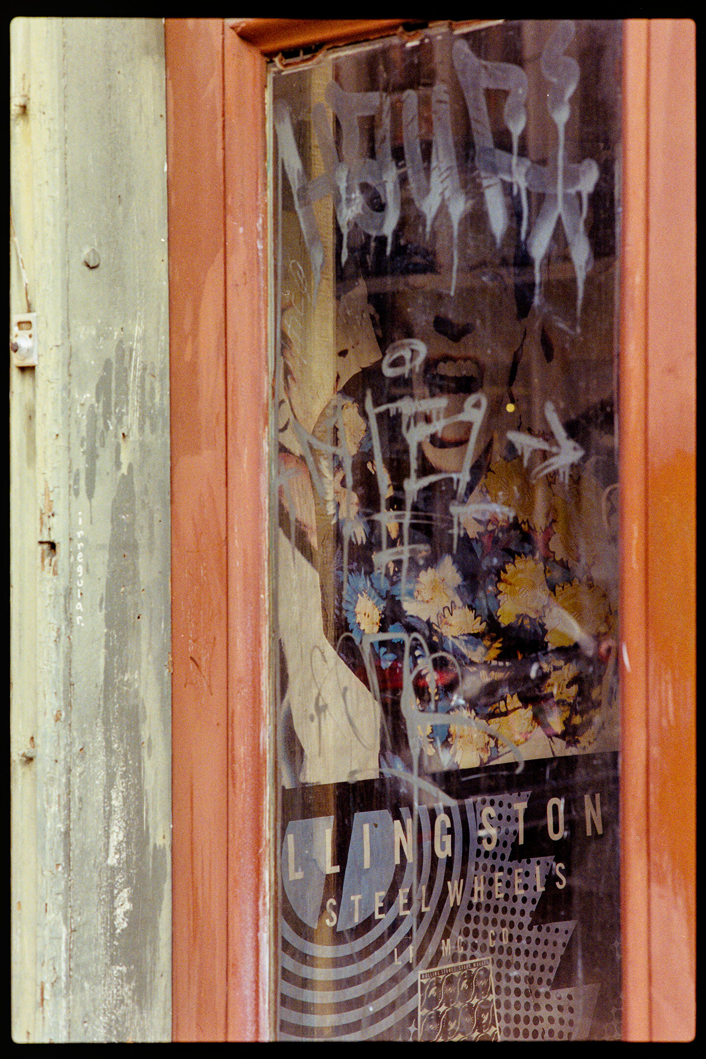 Looking into the window of a rundown record shop with a Rolling Stones Steel Wheels poster on the wall