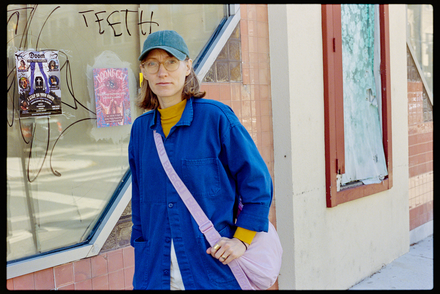 Kallie walking past an abandoned building