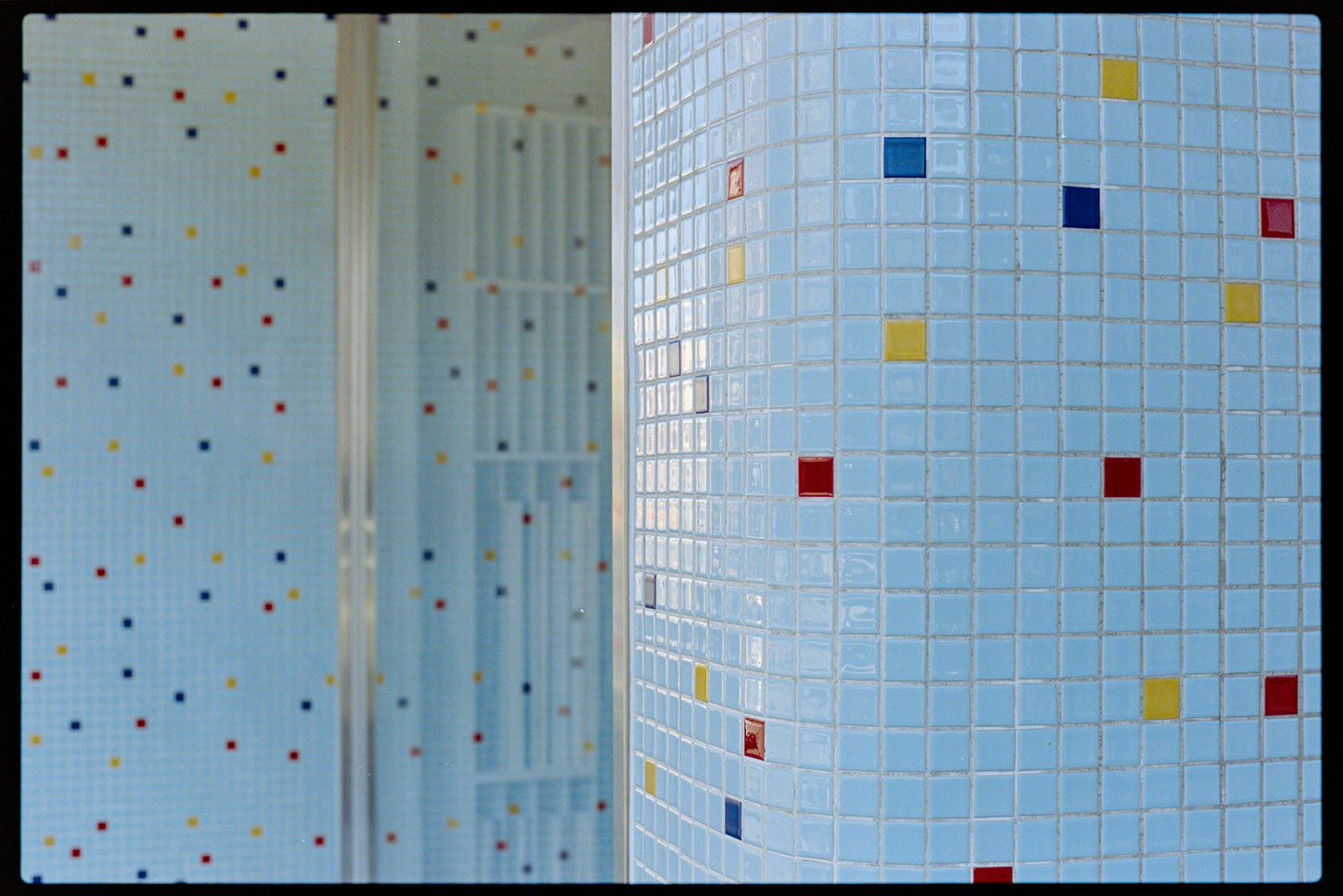 A store front covered in light blue tile