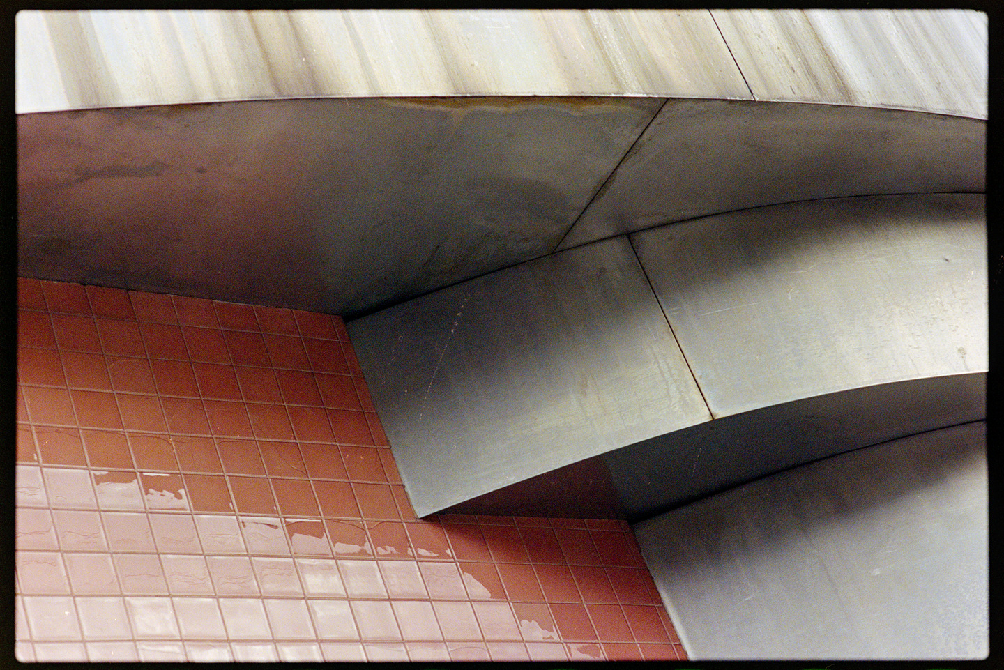 The red tile and metallic curves of the Essence building