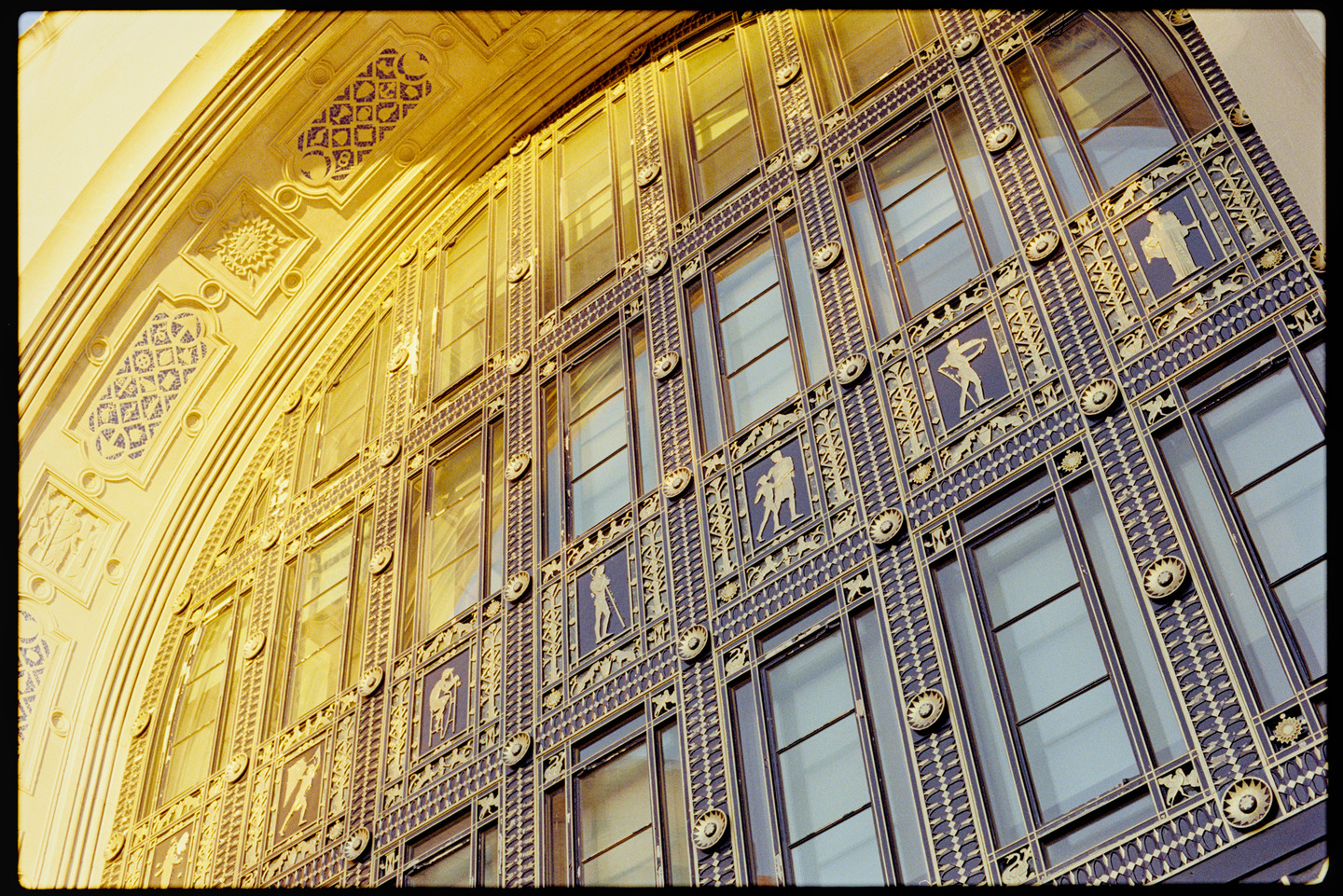 The dramatic windows above the front doors of the Philadelphia Museum of Art, glowing in sunset light