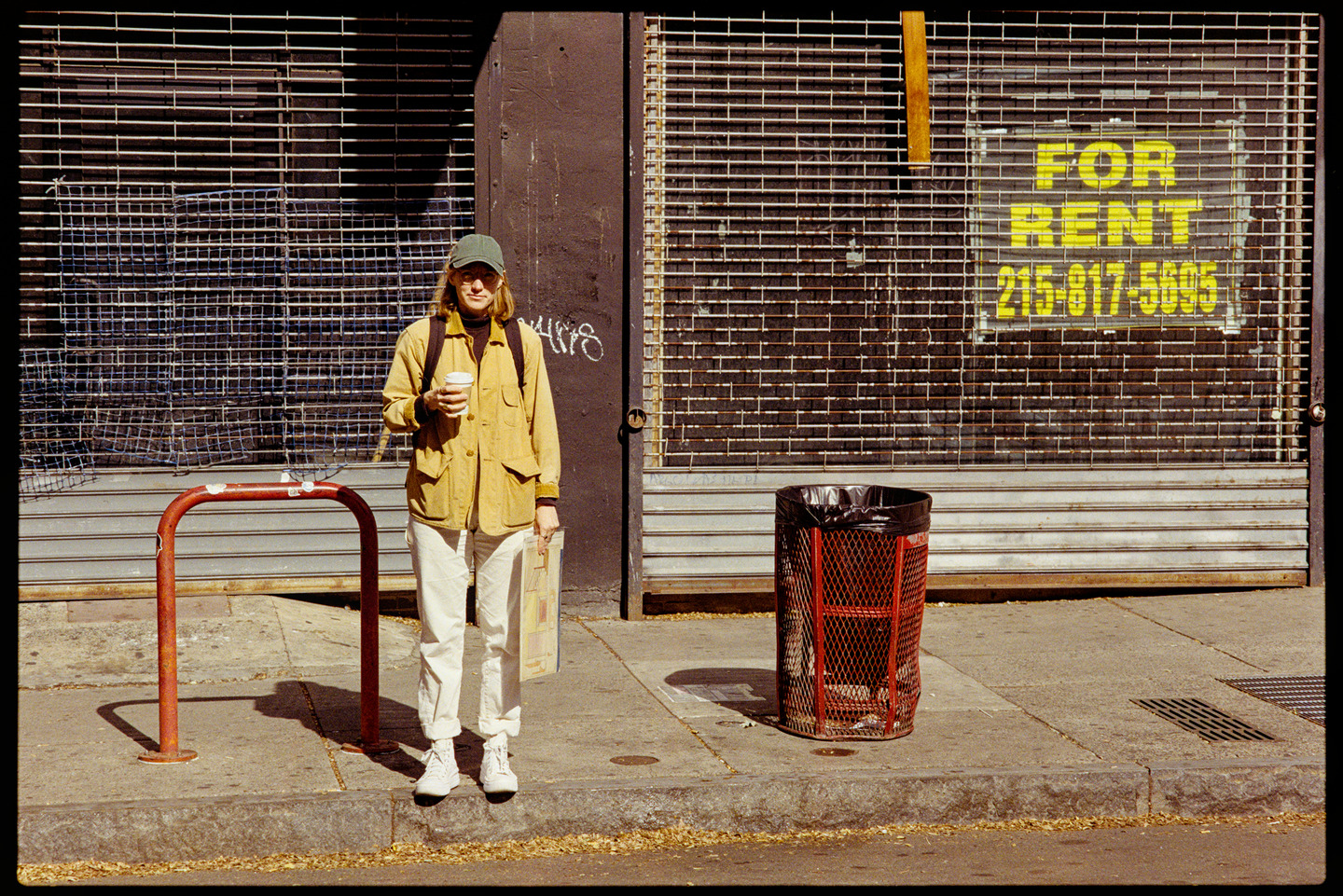Kallie standing in front of a store front with a for rent sign on it