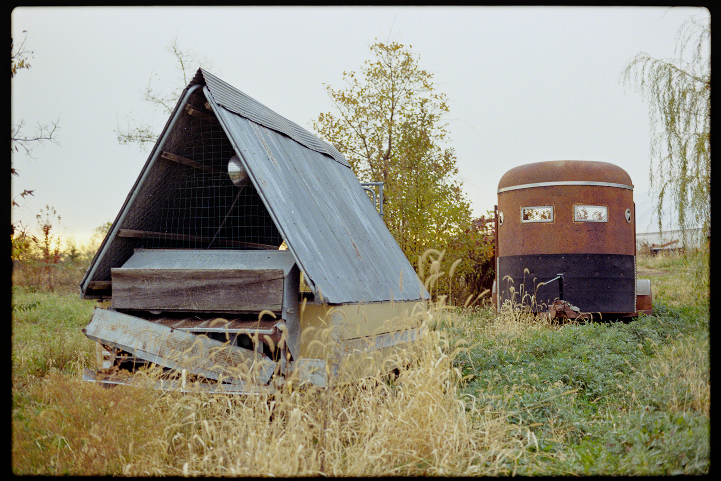 An a-frame chicken coup and a horse trailer at Spring Wind Farm