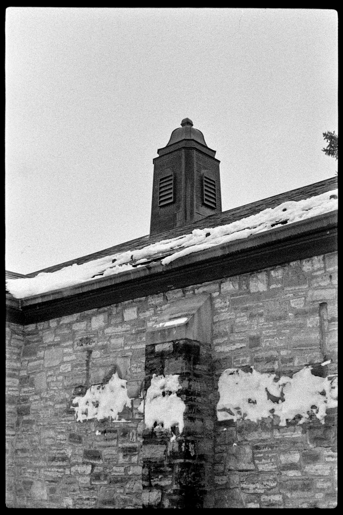 A metal vent sticking out of the roof of an old building at St. Olaf College
