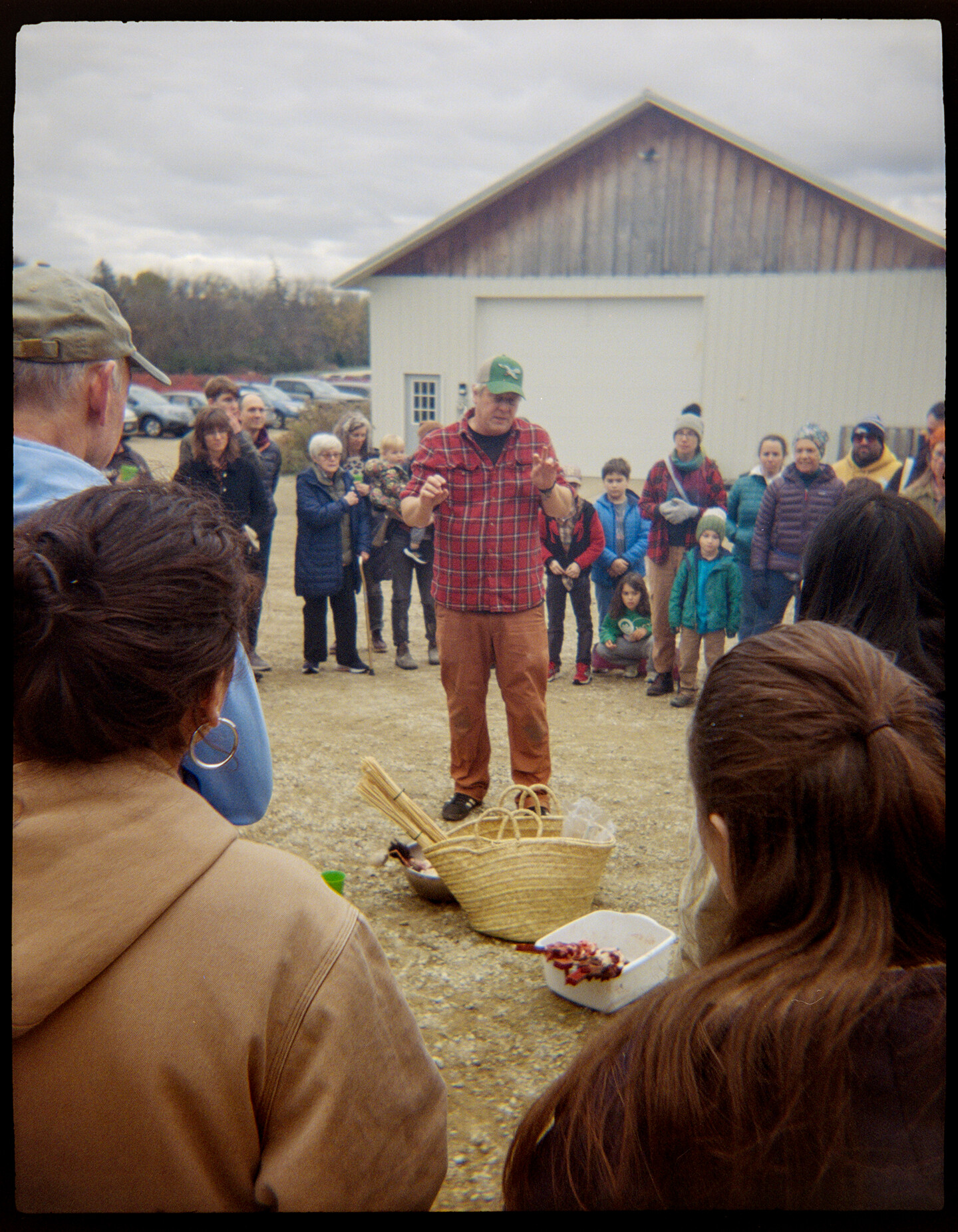A man standing in the middle of a crowd of people explaining an ancient Greek ritual