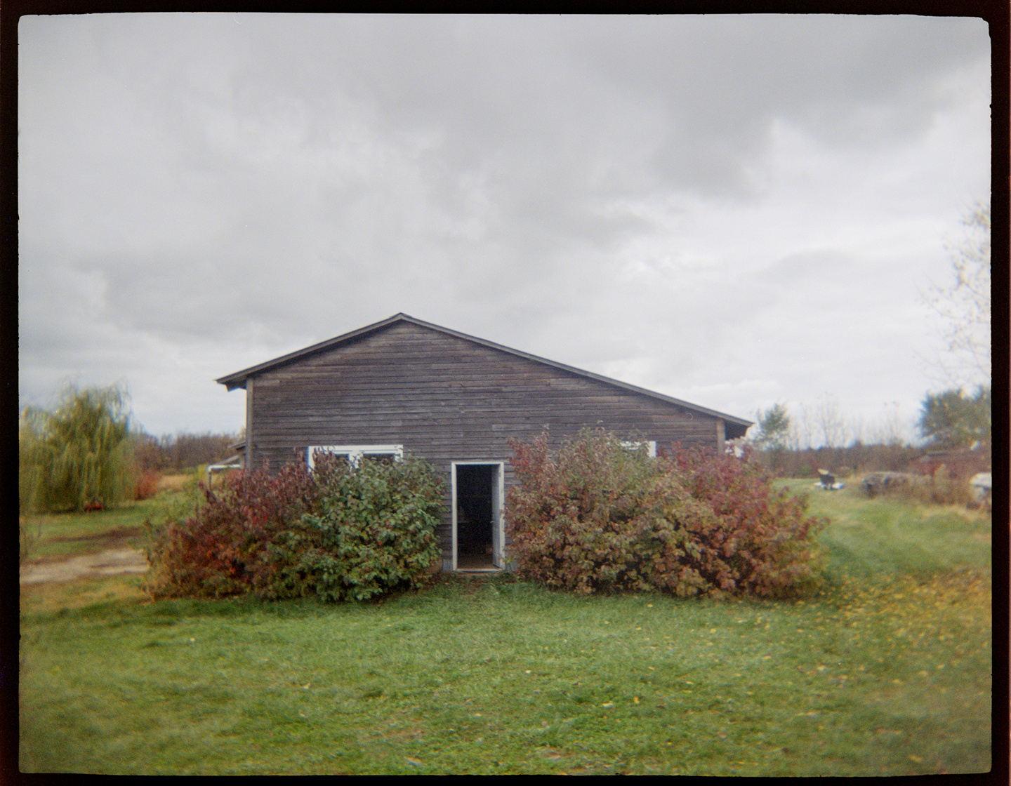 An old garage on a farmstead with an overcast sky above it