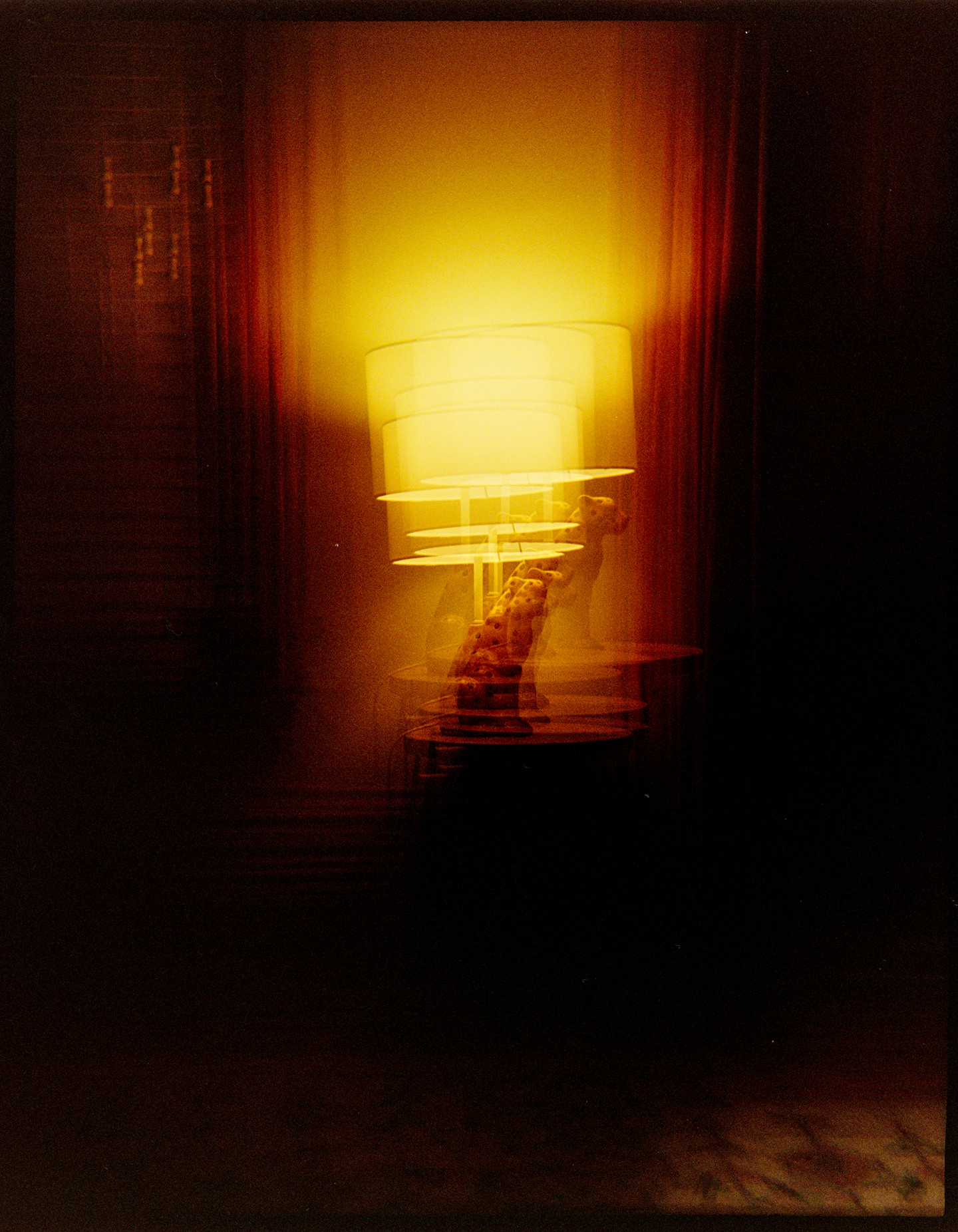 Multiple exposures of a lamp with a ceramic cheetah base in a living room